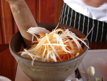 Adding the shredded papaya, carrots and tomatoes. Photo by Sandra Scott